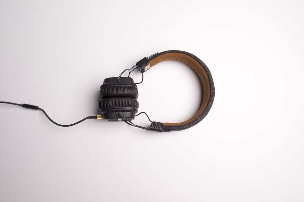 a set of brown and black wired headphones on an off-white background