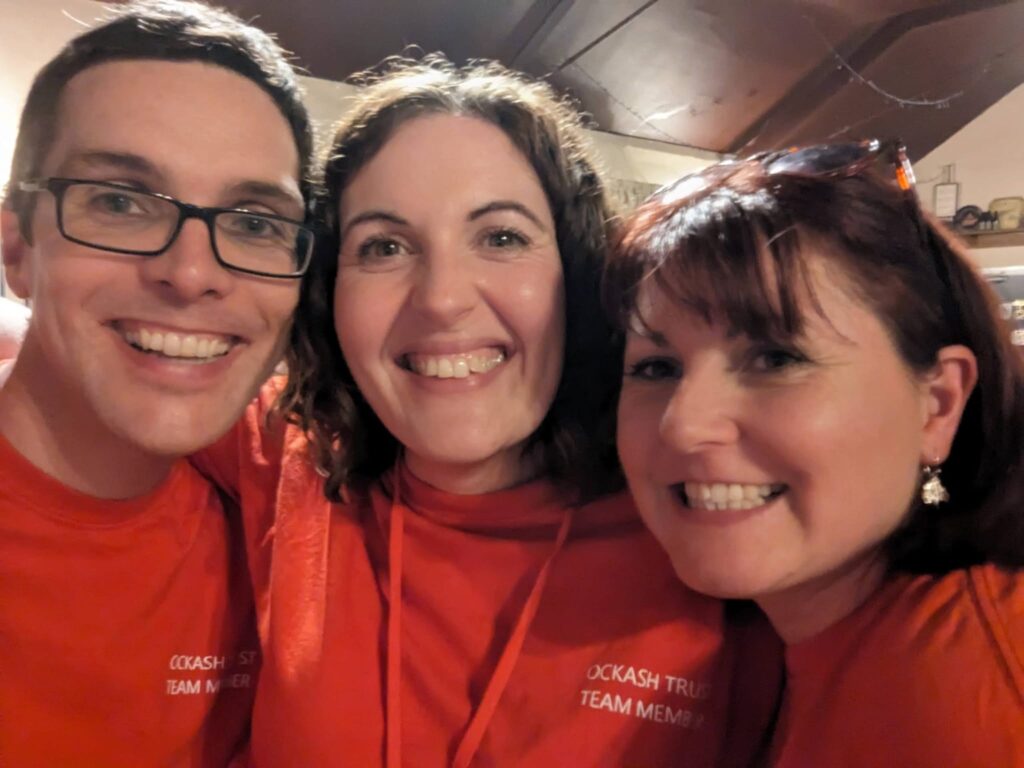 Smiling Ockash Trust volunteers in matching red T-shirts, which look itchy